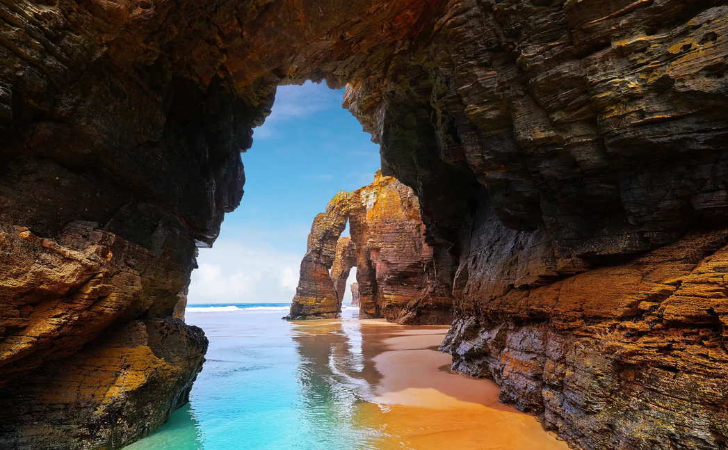 Natural rock arches and turquoise water at Praia das Catedrais